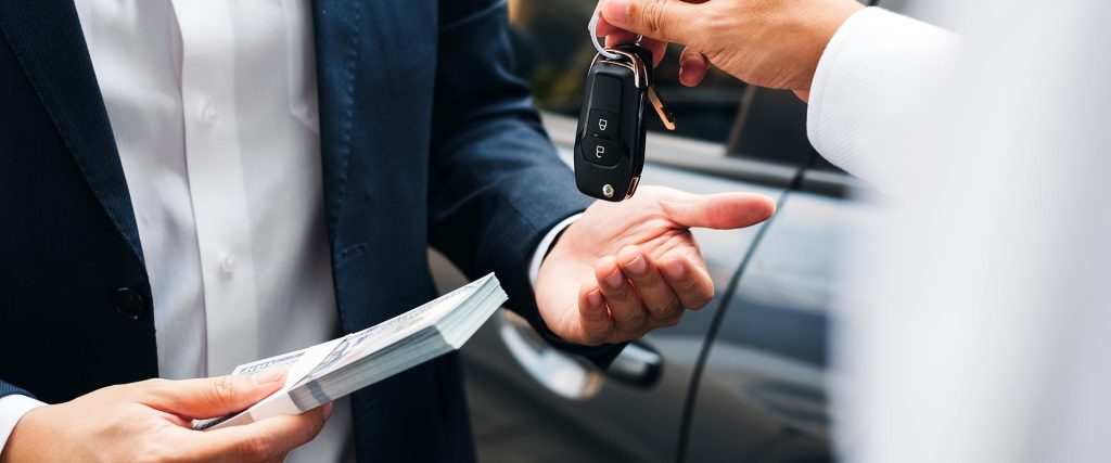 Exchanging a stack of cash for car keys.