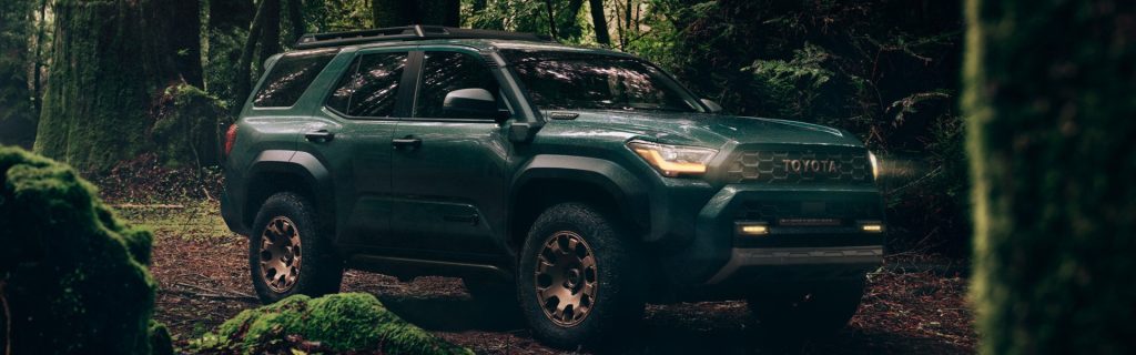 Dark green Toyota 4Runner parked in a lush forest